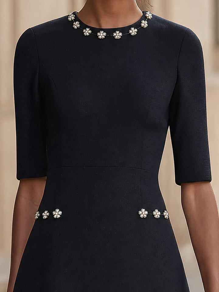 Dark blue A-line mini dress with a round neck and floral embellishment