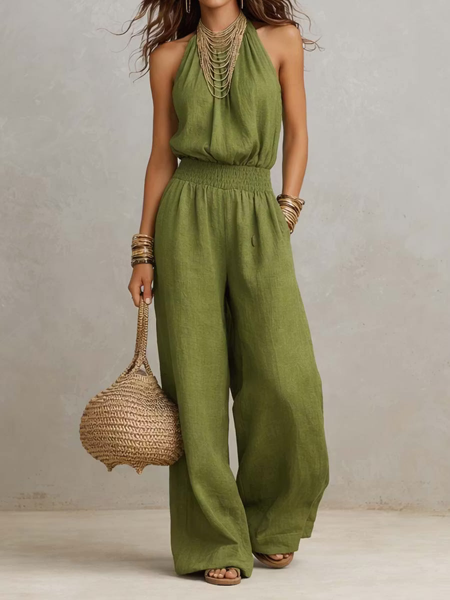 Cotton and linen jumpsuit with halter neckline, gathered waist, and wide legs.