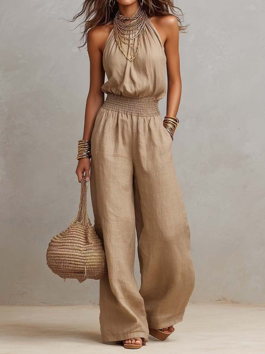 Cotton and linen jumpsuit with halter neckline, gathered waist, and wide legs.