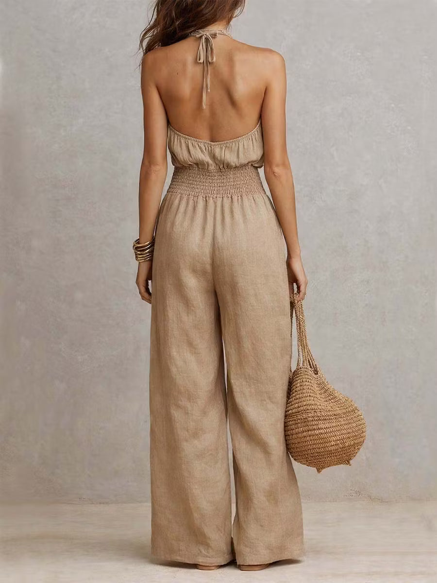 Cotton and linen jumpsuit with halter neckline, gathered waist, and wide legs.